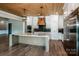 A kitchen featuring a marble countertop island, stainless appliances, and wooden ceiling at 110 Emmaline Ct, Troutman, NC 28166