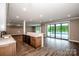 Open-concept living area with wet bar, hardwood floors, and view of the pool at 110 Emmaline Ct, Troutman, NC 28166