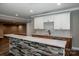 Living area with wet bar, open floor plan and stone bar at 110 Emmaline Ct, Troutman, NC 28166