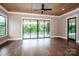 A living room with hardwood floors, a ceiling fan, and sliding glass doors to a deck at 110 Emmaline Ct, Troutman, NC 28166