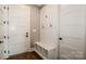 A mudroom with storage, a bench, and access to the garage and other parts of the house at 110 Emmaline Ct, Troutman, NC 28166