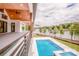 Exterior shot of a pool with lake views and a covered patio at 110 Emmaline Ct, Troutman, NC 28166
