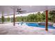 Relaxing pool area with lake view, featuring a built-in spa and a covered patio at 110 Emmaline Ct, Troutman, NC 28166
