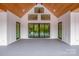 Cozy porch with wood ceiling, walls of windows and doors leading to the outdoor deck at 110 Emmaline Ct, Troutman, NC 28166