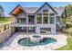 Aerial view of a grey home exterior with a back porch, patio, and a pool with a spa at 116 Emmaline Ct, Troutman, NC 28166
