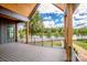 Beautiful covered back porch with wood ceiling, black railing, and lake view at 116 Emmaline Ct, Troutman, NC 28166