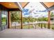A covered deck overlooks the backyard and lake at 116 Emmaline Ct, Troutman, NC 28166