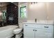 Modern bathroom features a bathtub, black tiled shower, and vanity with a marble countertop at 116 Emmaline Ct, Troutman, NC 28166