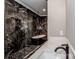 Stunning bathroom features a glass shower, marble tile, and soaking tub at 116 Emmaline Ct, Troutman, NC 28166
