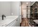 Stunning bathroom features a glass shower, marble tile, and white cabinets at 116 Emmaline Ct, Troutman, NC 28166