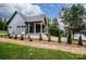Side view of the home showing landscaping and the back porch with views of the lake at 116 Emmaline Ct, Troutman, NC 28166