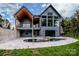 Rear view of the house with a swimming pool, hot tub, covered porch, and many windows at 116 Emmaline Ct, Troutman, NC 28166