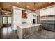 Open kitchen featuring white cabinets, a wood island, stainless steel appliances, and wood ceiling at 116 Emmaline Ct, Troutman, NC 28166