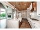 Open concept kitchen featuring white cabinets, an island, and adjoins the living room at 116 Emmaline Ct, Troutman, NC 28166