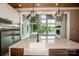 Kitchen with stainless steel appliances, white cabinets, and lake views through a large living room window at 116 Emmaline Ct, Troutman, NC 28166