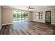 Spacious living room featuring hardwood floors and sliding glass doors opening to a pool at 116 Emmaline Ct, Troutman, NC 28166