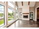 Bright living room features floor to ceiling windows, fireplace, and beautiful wood floors at 116 Emmaline Ct, Troutman, NC 28166