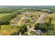 Aerial view of a residential neighborhood with lush green lawns and mature trees in a serene setting at 104 Castle Pines Ln, Statesville, NC 28625