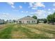 Large, grassy backyard surrounded by neighboring homes and mature trees adds to the property's appeal at 104 Castle Pines Ln, Statesville, NC 28625