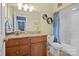 Bathroom featuring a granite countertop vanity, toilet, and tub with blue shower curtain at 104 Castle Pines Ln, Statesville, NC 28625