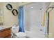 Bathroom with a toilet, tub/shower with blue curtain and hexagon decor at 104 Castle Pines Ln, Statesville, NC 28625