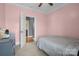 A bedroom featuring soft carpet, neutral walls, and a doorway leading to the hall and bathroom at 104 Castle Pines Ln, Statesville, NC 28625