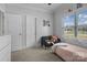 Bright bedroom with natural light, showcasing a comfortable seating area and soft carpeting at 104 Castle Pines Ln, Statesville, NC 28625