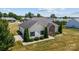 Stunning one-story home featuring manicured landscaping, a stone facade, and mature trees at 104 Castle Pines Ln, Statesville, NC 28625