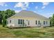 Exterior shot of home shows nice landscaping, attached patio and spacious backyard at 104 Castle Pines Ln, Statesville, NC 28625