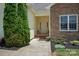 Inviting front porch with a cozy seating area, stone accents, and well-maintained landscaping at 104 Castle Pines Ln, Statesville, NC 28625