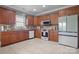Well-equipped kitchen featuring granite countertops, updated appliances and ample wooden cabinetry at 104 Castle Pines Ln, Statesville, NC 28625
