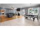 Open-concept living area and dining area for seamless entertaining, with the living area featuring a cozy fireplace at 104 Castle Pines Ln, Statesville, NC 28625