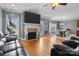 Bright open concept living room with hardwood floors, fireplace, and dining area at 104 Castle Pines Ln, Statesville, NC 28625