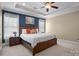 Spacious main bedroom featuring a tray ceiling, large windows, and neutral tones at 104 Castle Pines Ln, Statesville, NC 28625