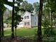 Charming two-story home with gray siding, black shutters, and attached two-car garage surrounded by lush trees at 109 Florence Rd, Statesville, NC 28625