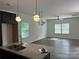 Open-concept kitchen with granite countertops and modern pendant lighting at 109 Florence Rd, Statesville, NC 28625