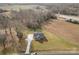 Captivating aerial perspective showcases a gray single-story home with an extended driveway amidst fields and trees at 8255 W Nc 10 Hwy, Vale, NC 28168