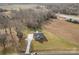 A charming gray home is set on a spacious, verdant lot with a long driveway and a picturesque rural backdrop at 8255 W Nc 10 Hwy, Vale, NC 28168
