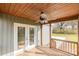 Covered porch featuring wooden floors and ceiling with fan, and a view of a tree filled yard at 8255 W Nc 10 Hwy, Vale, NC 28168