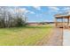 An expansive backyard view highlights the generous outdoor space, complemented by the home's wooden porch and trees at 8255 W Nc 10 Hwy, Vale, NC 28168