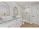 Bright bathroom with double vanity featuring granite counters, white cabinets and gold hardware at 8255 W Nc 10 Hwy, Vale, NC 28168