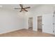 Bright bedroom with modern ceiling fan, ensuite bathroom, walk-in closet, white trim, and hardwood floors at 8255 W Nc 10 Hwy, Vale, NC 28168