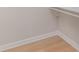 View of the corner of a closet with white walls, floor trim, wood floors and hanging rod at 8255 W Nc 10 Hwy, Vale, NC 28168