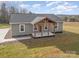 Attractive single-story home showcasing a covered wooden porch and low maintenance landscaping on a sunny day at 8255 W Nc 10 Hwy, Vale, NC 28168