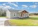 A well-maintained single-story home with a covered porch, siding, and a long driveway at 8255 W Nc 10 Hwy, Vale, NC 28168