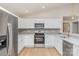 Bright kitchen featuring stainless steel appliances, white cabinets and countertops, and subway tile backsplash at 8255 W Nc 10 Hwy, Vale, NC 28168