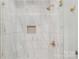 This shower stall features white marble patterned tile with elegant gold fixtures and recessed shelf at 8255 W Nc 10 Hwy, Vale, NC 28168
