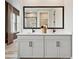 Bathroom featuring a dual sink vanity with black fixtures, a black framed mirror and marbled tile floors at 133 Armstrong Rd, Belmont, NC 28012
