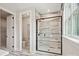 Modern bathroom featuring a glass shower with gray, white and black marble tiling, and black fixtures at 133 Armstrong Rd, Belmont, NC 28012