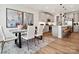 Stylish dining area near an open kitchen, complemented by contemporary art and sleek furnishings, perfect for modern living at 133 Armstrong Rd, Belmont, NC 28012
